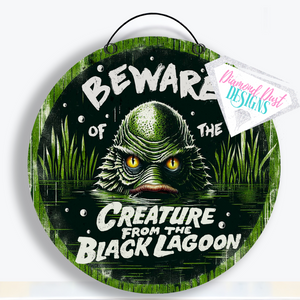 Beware of the Creature from the Black Lagoon round wood sign.