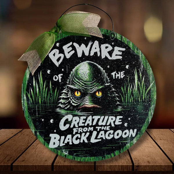 Beware of the Creature from the Black Lagoon round wood sign.