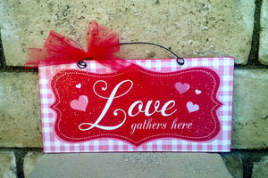 Love gathers here. Valentines sign.
