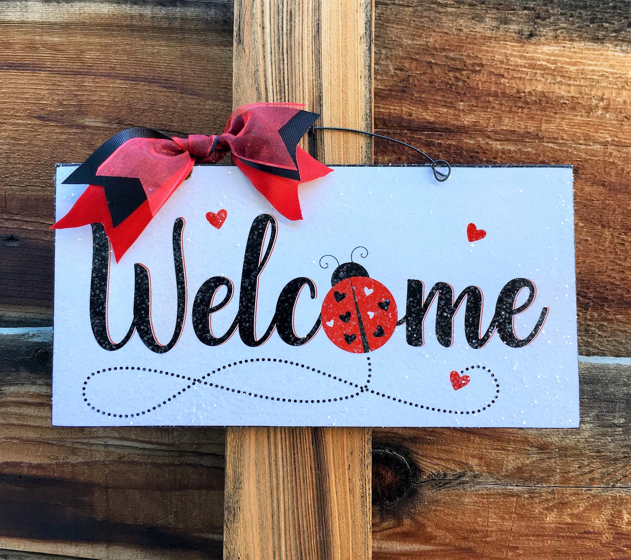 Welcome Ladybug with hearts sign.