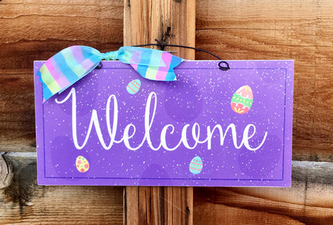Welcome Easter sign with eggs.